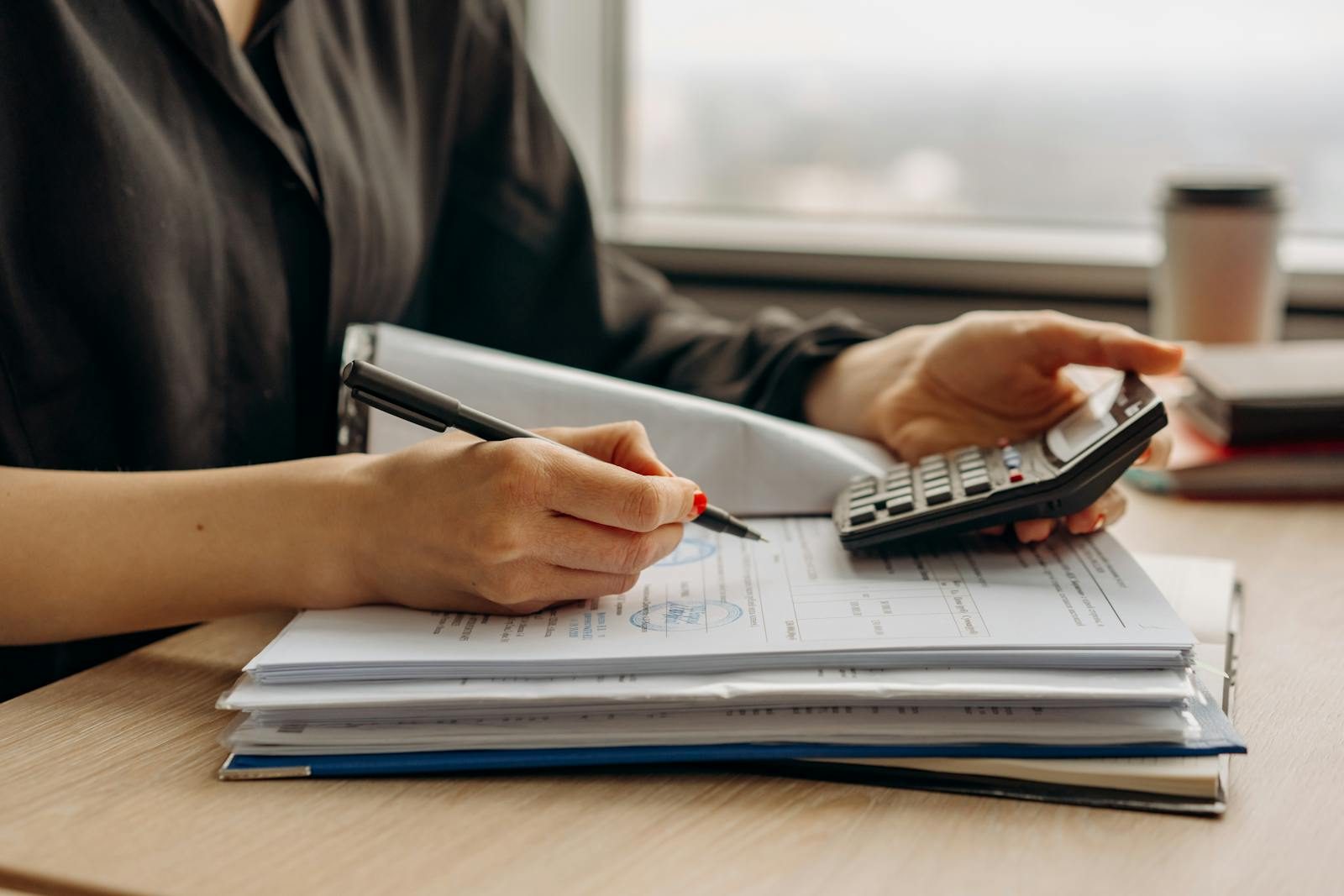 Financial documents and calculator on a desk, representing the pressure facing charities and the case for governance review.